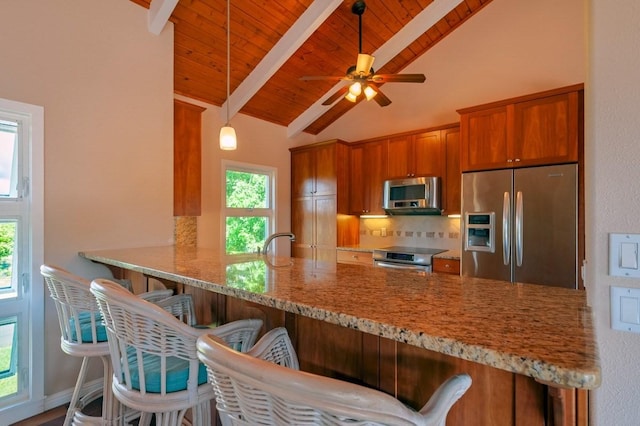 3636 Keoniana Rd, Princeville, HI 96722 - kitchen featuring stainless steel appliances, a peninsula, brown cabinetry, tasteful backsplash, and wooden ceiling with exposed beams