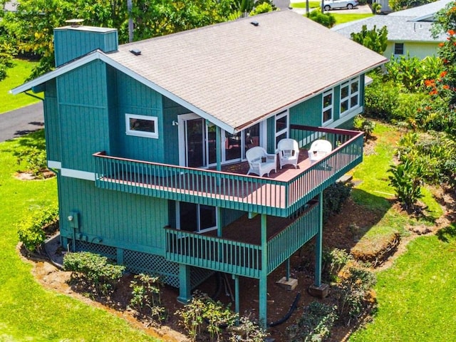 3636 Keoniana Rd, Princeville, HI 96722 - back of house with a deck, a chimney, a shingled roof, and a yard