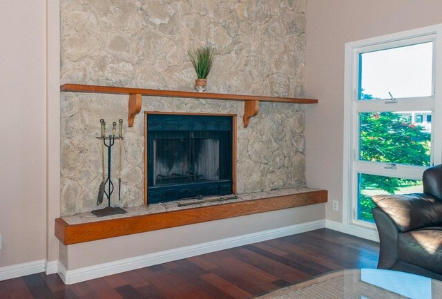3636 Keoniana Rd, Princeville, HI 96722 - detailed view of wood finished floors, a fireplace with raised hearth, and baseboards