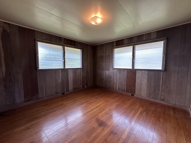 5684 Wailaau Rd, Koloa, HI 96756 - spare room featuring hardwood / wood-style flooring, healthy amount of natural light, and wooden walls