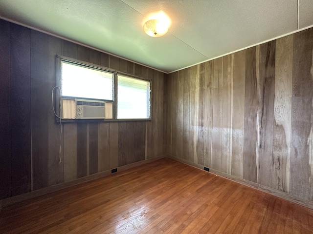 5684 Wailaau Rd, Koloa, HI 96756 - empty room featuring hardwood / wood-style floors, cooling unit, and wooden walls