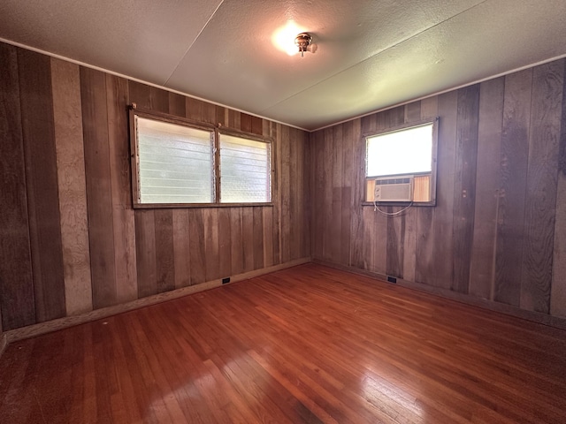 5684 Wailaau Rd, Koloa, HI 96756 - empty room with cooling unit, hardwood / wood-style flooring, and wood walls