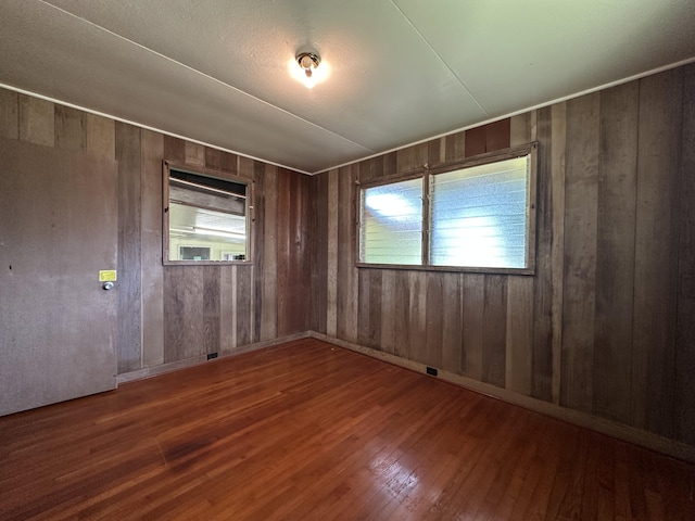 5684 Wailaau Rd, Koloa, HI 96756 - empty room featuring wood finished floors, healthy amount of natural light, and wood walls
