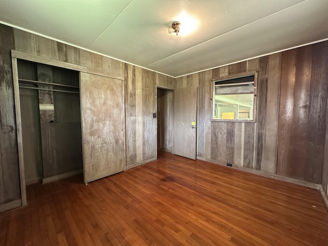 5684 Wailaau Rd, Koloa, HI 96756 - unfurnished bedroom featuring wood finished floors, a closet, and wooden walls