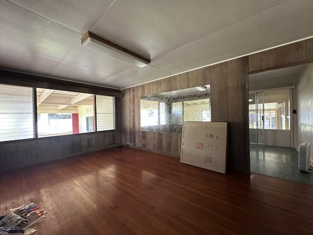 5684 Wailaau Rd, Koloa, HI 96756 - empty room with wooden walls, wood finished floors, and a textured ceiling