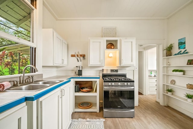 2819 Kapena St, Lihue, HI 96766 - kitchen with stainless steel gas stove, open shelves, a sink, white cabinetry, and light wood finished floors