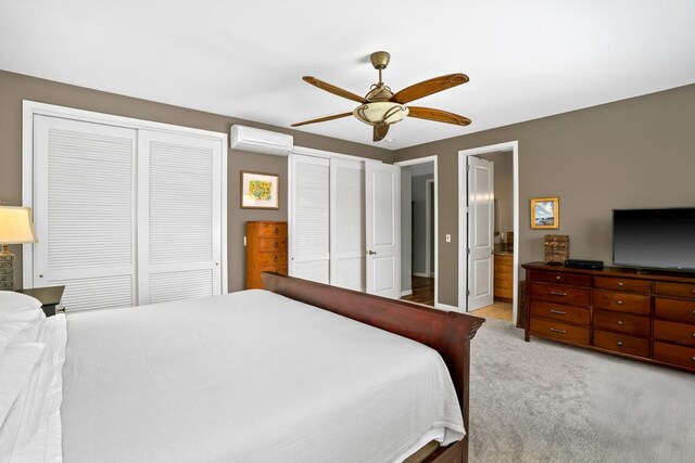 4355 Liliuokalani Pl, Kilauea, HI 96754 - bedroom featuring an AC wall unit, two closets, light carpet, a ceiling fan, and ensuite bathroom