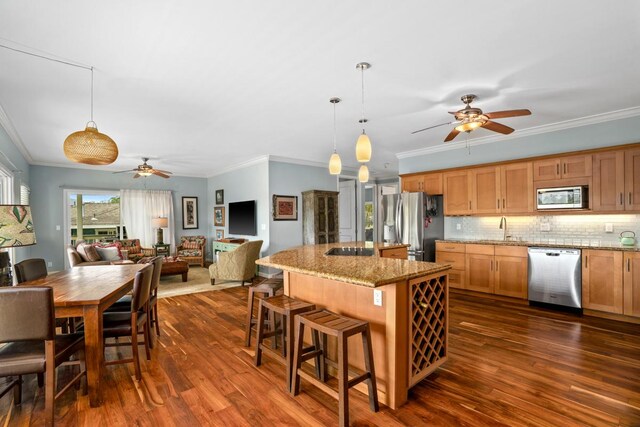 4355 Liliuokalani Pl, Kilauea, HI 96754 - kitchen with appliances with stainless steel finishes, a ceiling fan, a sink, crown molding, and tasteful backsplash