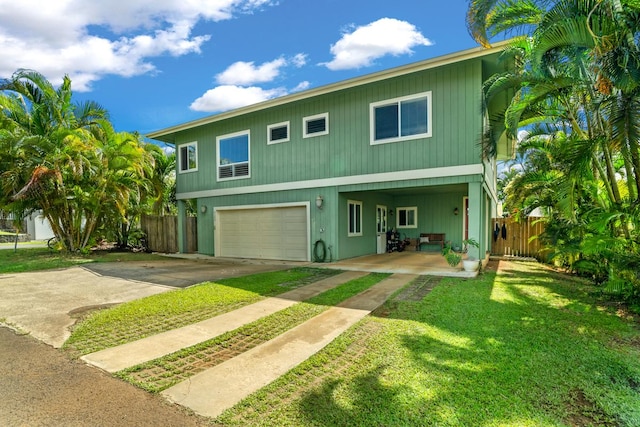 4355 Liliuokalani Pl, Kilauea, HI 96754 - raised beach house with an attached garage and driveway