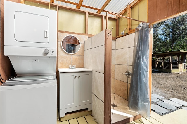 92-8856 Orchid Pkwy, Ocean View, HI 96737 - washroom featuring stacked washing machine and dryer and tile walls