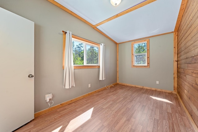 92-8856 Orchid Pkwy, Ocean View, HI 96737 - spare room with plenty of natural light, lofted ceiling, wood finished floors, baseboards, and wood walls