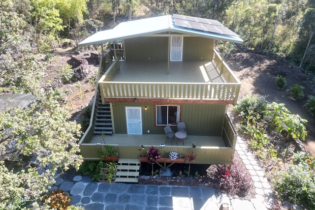 92-8856 Orchid Pkwy, Ocean View, HI 96737 - view of front of house featuring stairway, a wooded view, and a wooden deck