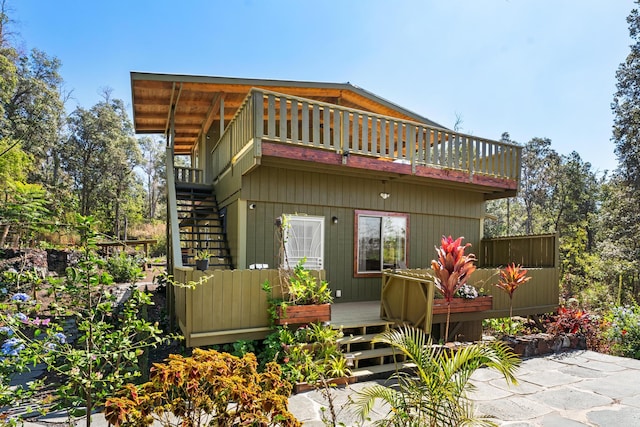 92-8856 Orchid Pkwy, Ocean View, HI 96737 - rear view of property with a wooden deck and stairs