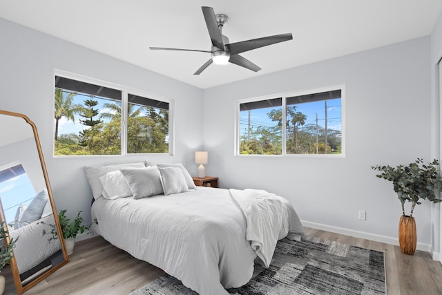 15-1754 Paradise Dr, Keaau, HI 96749 - bedroom featuring wood finished floors, baseboards, and a ceiling fan