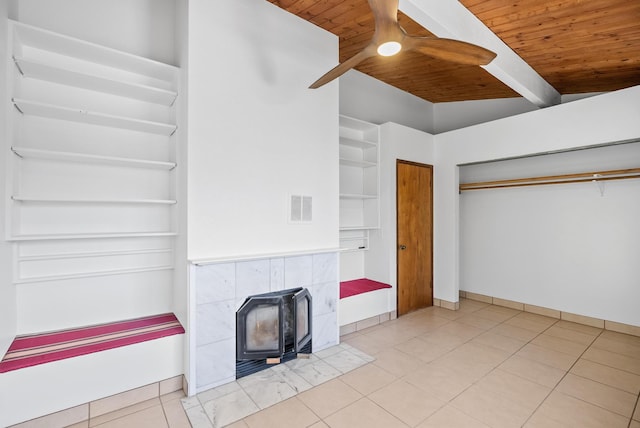 92-8821 Orchid Pkwy, Ocean View, HI 96737 - unfurnished living room with wood ceiling with exposed beams, a wood stove, a ceiling fan, tile patterned floors, and baseboards