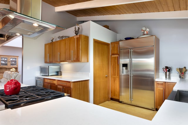 71-1769 Puu Lani Dr, Kailua-Kona, HI 96740 - kitchen with stainless steel appliances, brown cabinets, ventilation hood, light countertops, and light wood-style floors