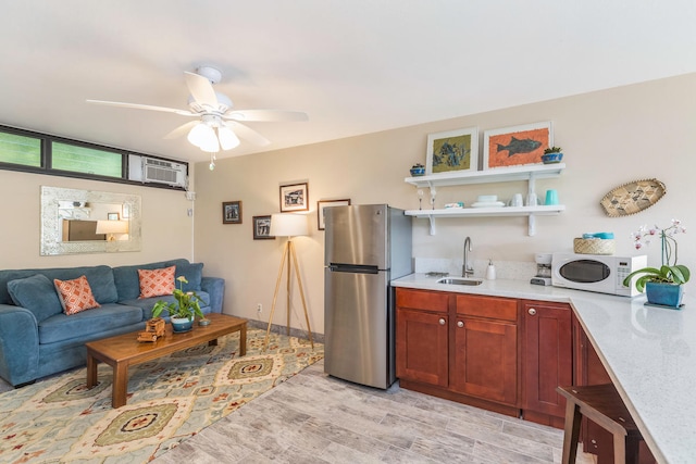5301 Ka Haku Rd Unit 112, Princeville, HI 96722 - kitchen featuring freestanding refrigerator, white microwave, a sink, light wood-style floors, and ceiling fan
