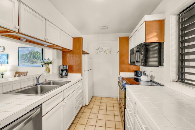 2253 Poipu Rd Unit 241, Koloa, HI 96756 - kitchen with tile countertops, electric stove, freestanding refrigerator, a sink, and stainless steel dishwasher