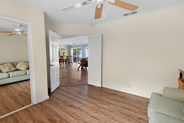 77-6596 Walua Rd, Kailua-Kona, HI 96740 - living area featuring ceiling fan, wood finished floors, and baseboards