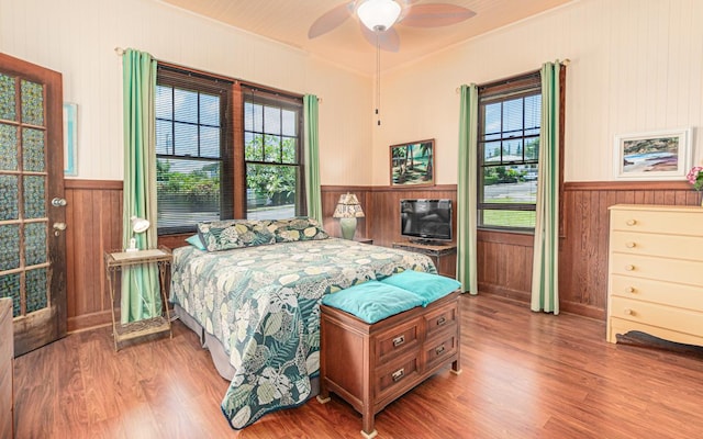 394 Haili St, Hilo, HI 96720 - bedroom with a wainscoted wall, wooden walls, wood finished floors, crown molding, and ceiling fan