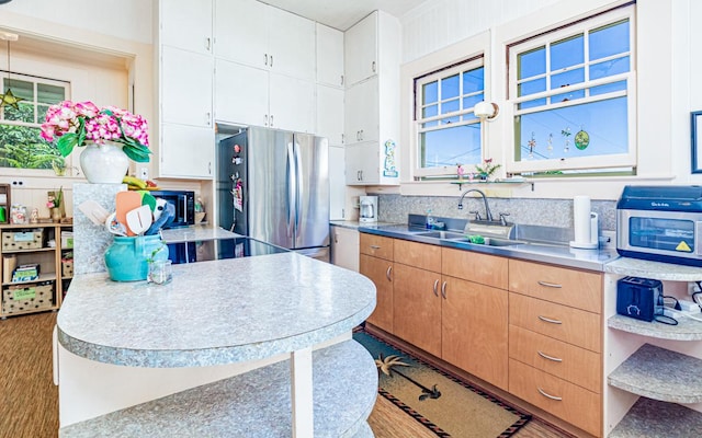 394 Haili St, Hilo, HI 96720 - kitchen featuring a sink, freestanding refrigerator, and white cabinets