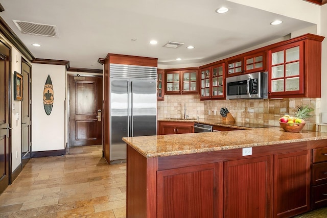 4-820 Kuhio Hwy Unit C306, Kapaa, HI 96746 - kitchen featuring stainless steel appliances, a sink, tasteful backsplash, baseboards, and a peninsula