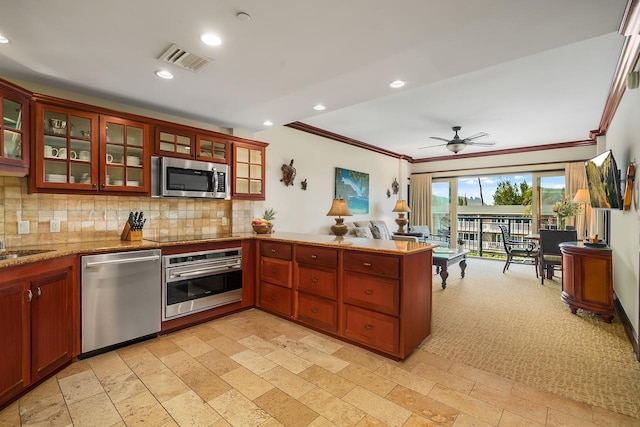4-820 Kuhio Hwy Unit C306, Kapaa, HI 96746 - kitchen with appliances with stainless steel finishes, a peninsula, recessed lighting, decorative backsplash, and crown molding