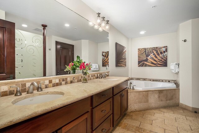 4-820 Kuhio Hwy Unit C306, Kapaa, HI 96746 - full bathroom with stone tile floors, double vanity, a bath, recessed lighting, and baseboards