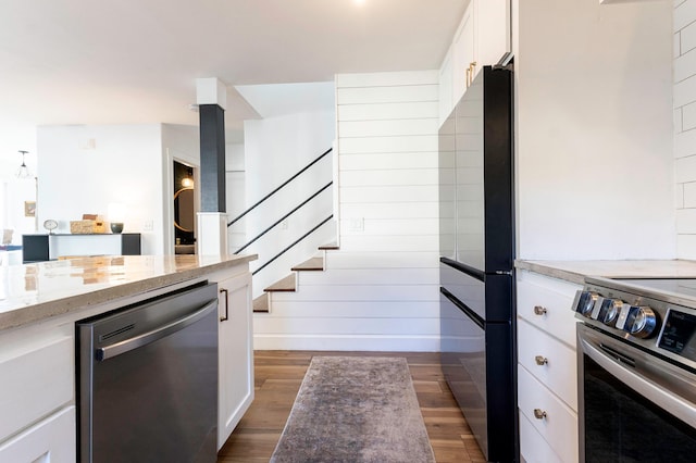 189 Poouli St, Wailuku, HI 96793 - kitchen with appliances with stainless steel finishes, white cabinetry, dark wood-style flooring, light stone countertops, and baseboards