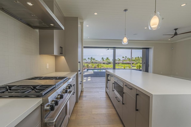 73-4804 Hinahina Rd Unit 13, Kailua-Kona, HI 96740 - kitchen with wall chimney exhaust hood, appliances with stainless steel finishes, light wood-style flooring, recessed lighting, and light countertops