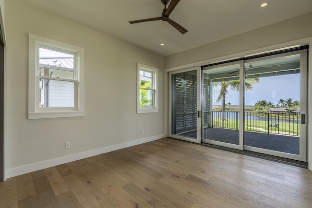 73-4804 Hinahina Rd Unit 13, Kailua-Kona, HI 96740 - unfurnished room with ceiling fan, baseboards, a water view, wood finished floors, and recessed lighting