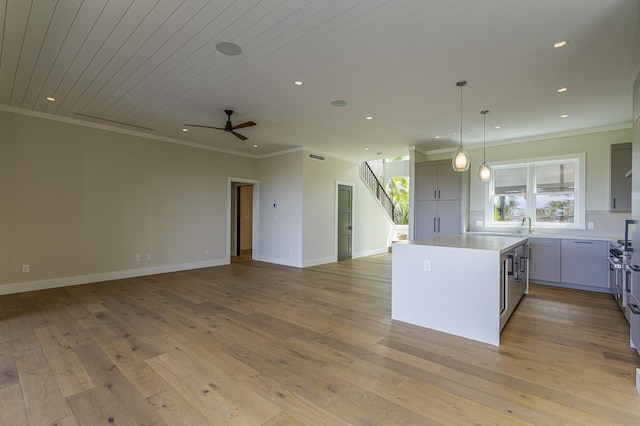 73-4804 Hinahina Rd Unit 13, Kailua-Kona, HI 96740 - kitchen featuring ornamental molding, a kitchen island, ceiling fan, open floor plan, and light countertops