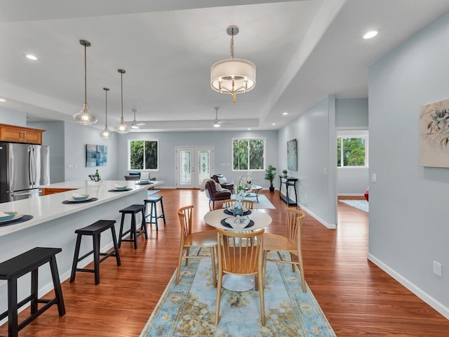15-1047 Pilikai Rd, Keaau, HI 96749 - dining area with wood finished floors, ceiling fan, baseboards, a tray ceiling, and recessed lighting