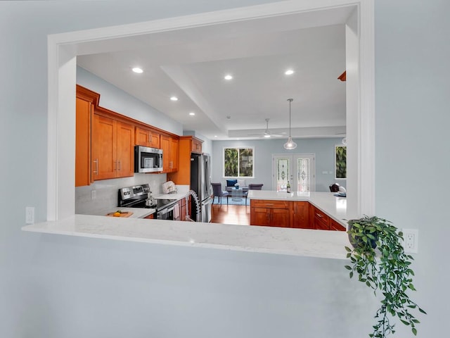 15-1047 Pilikai Rd, Keaau, HI 96749 - kitchen featuring appliances with stainless steel finishes, recessed lighting, brown cabinetry, a peninsula, and hanging light fixtures