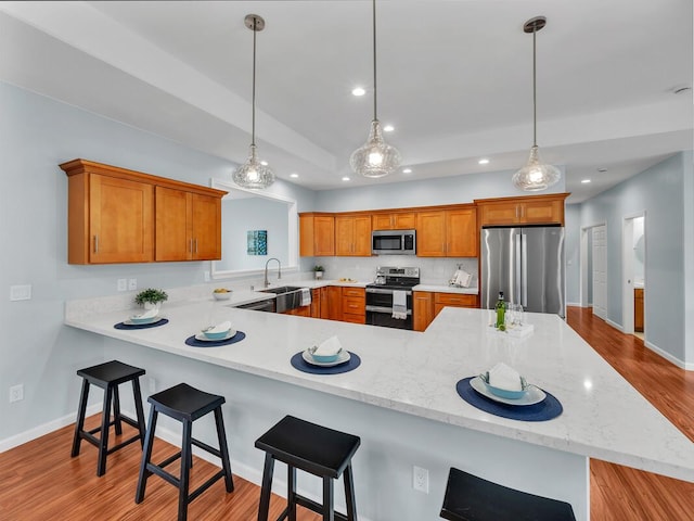 15-1047 Pilikai Rd, Keaau, HI 96749 - kitchen featuring stainless steel appliances, a sink, recessed lighting, light wood-type flooring, and brown cabinets