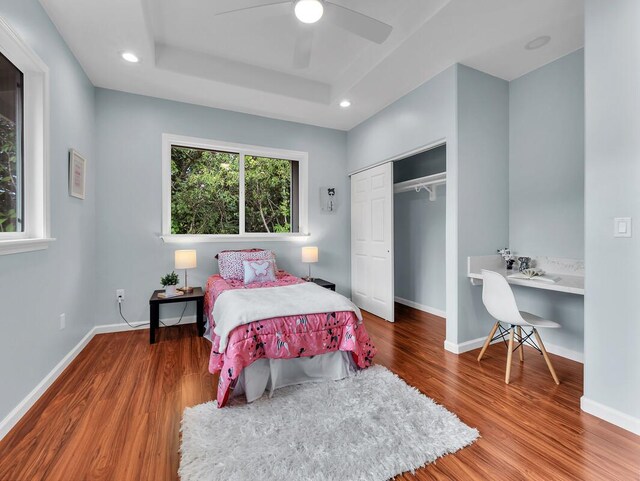 15-1047 Pilikai Rd, Keaau, HI 96749 - bedroom with wood finished floors, a closet, baseboards, recessed lighting, and a tray ceiling