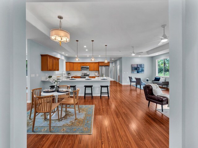 15-1047 Pilikai Rd, Keaau, HI 96749 - dining room with wood finished floors, ceiling fan, baseboards, a raised ceiling, and recessed lighting