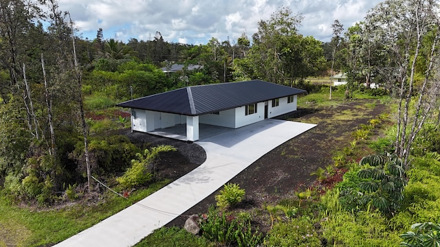 15-2812 Lai St, Pahoa, HI 96778 - view of home's community featuring concrete driveway, an attached carport, and a view of trees