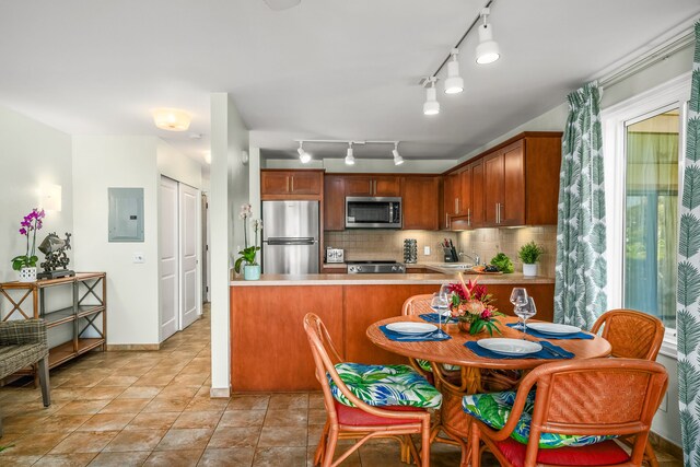 4-1250 Kuhio Hwy Unit H104, Kapaa, HI 96746 - kitchen with appliances with stainless steel finishes, electric panel, light countertops, decorative backsplash, and rail lighting