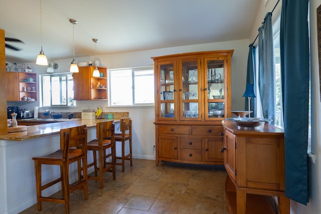 15-1517 7th Ave, Keaau, HI 96749 - kitchen with open shelves, pendant lighting, a kitchen breakfast bar, and brown cabinetry