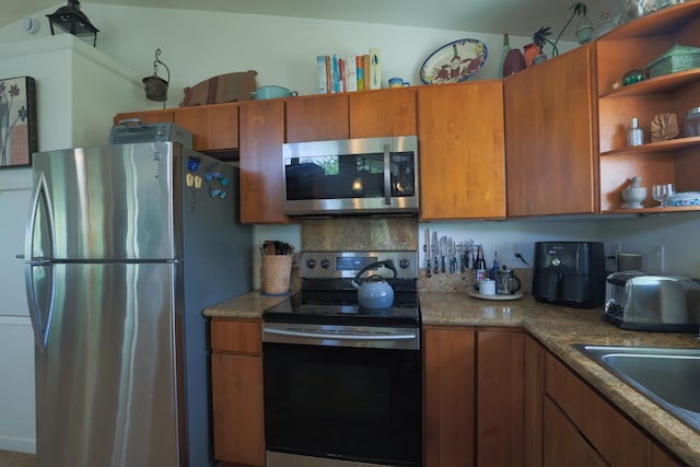 15-1517 7th Ave, Keaau, HI 96749 - kitchen with stainless steel appliances, brown cabinetry, open shelves, and a sink