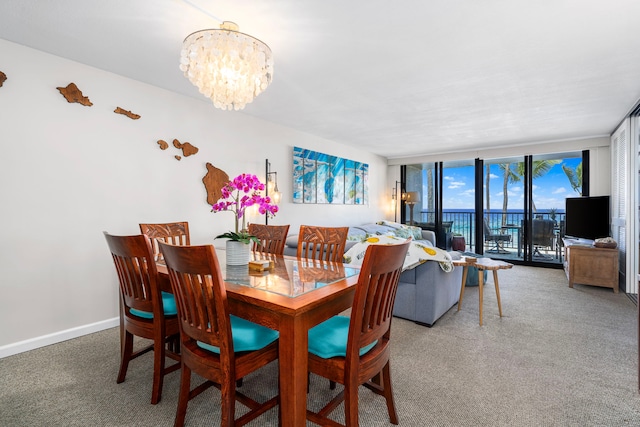 75-6106 Alii Dr Unit 208, Kailua-Kona, HI 96740 - carpeted dining space with a chandelier, expansive windows, and baseboards