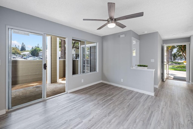 68-3890 Lua Kula St Unit 1104, Waikoloa, HI 96738 - empty room featuring wood finished floors, healthy amount of natural light, a textured ceiling, and baseboards