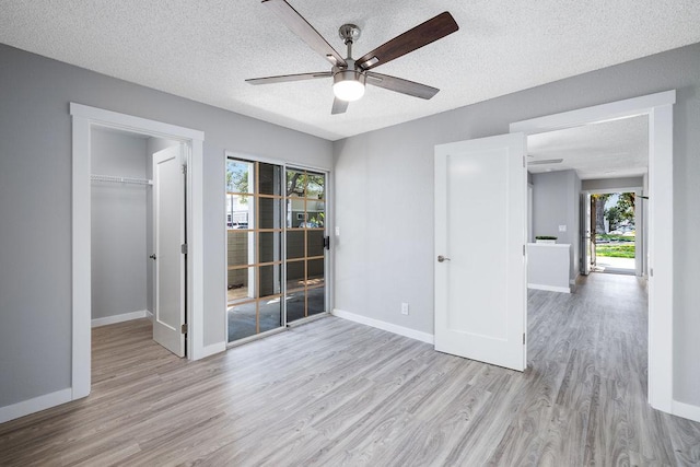 68-3890 Lua Kula St Unit 1104, Waikoloa, HI 96738 - empty room featuring a ceiling fan, wood finished floors, a textured ceiling, and baseboards