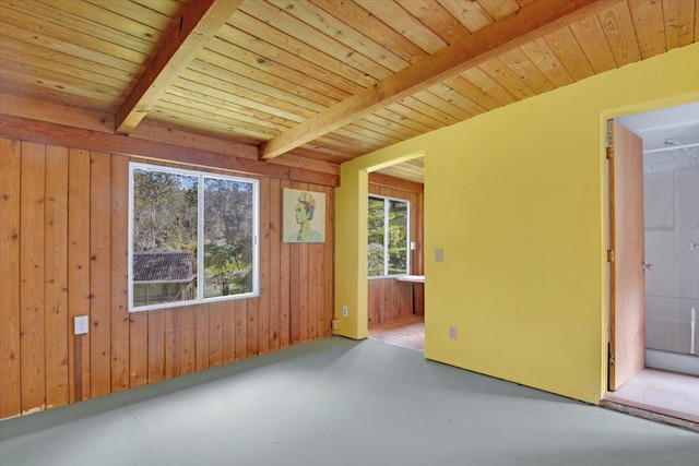 11-3953 Liona St, Volcano, HI 96785 - spare room with concrete floors, wood walls, and wooden ceiling with exposed beams