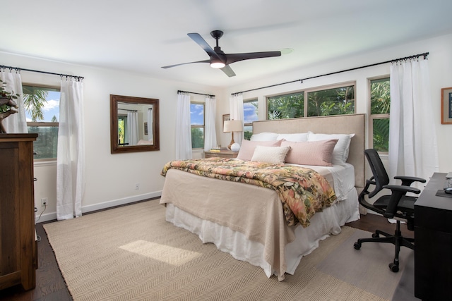 68-3932 Mulei Pl, Waikoloa, HI 96738 - bedroom with wood finished floors, baseboards, a ceiling fan, and a desk