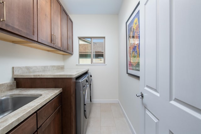 68-3932 Mulei Pl, Waikoloa, HI 96738 - laundry area featuring washer and dryer, cabinet space, baseboards, and light tile patterned floors