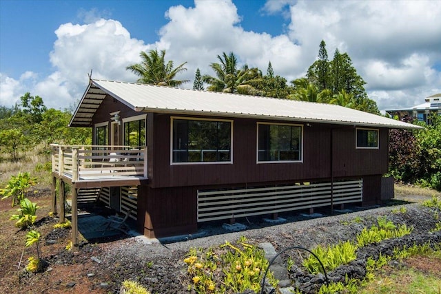 12-138 Oliana Dr, Pahoa, HI 96778 - view of side of home with metal roof and a wooden deck