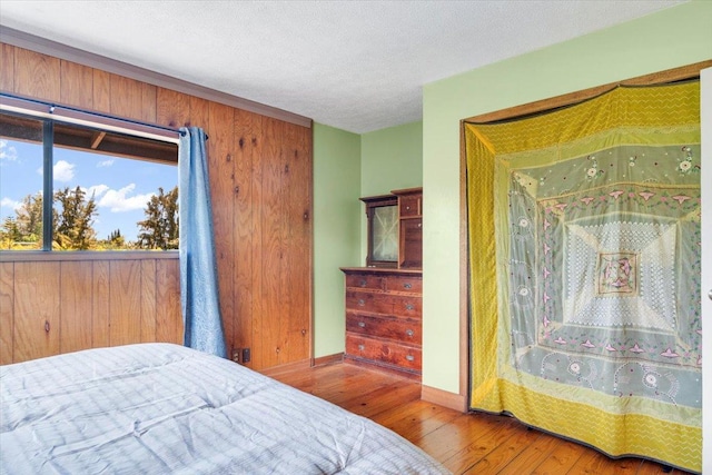 12-138 Oliana Dr, Pahoa, HI 96778 - bedroom with hardwood / wood-style floors, baseboards, and a textured ceiling