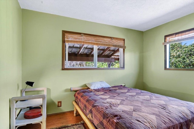 12-138 Oliana Dr, Pahoa, HI 96778 - bedroom with wood finished floors and a textured ceiling